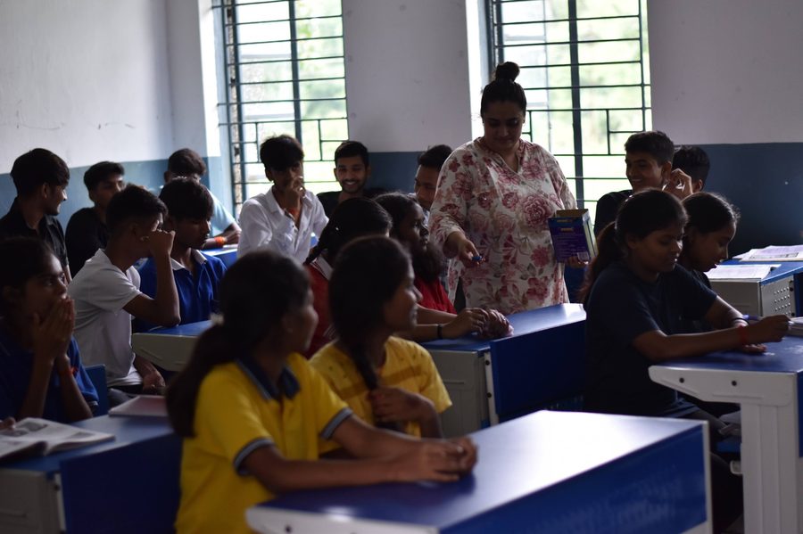 A facilitator sharing treats with students during a workshop