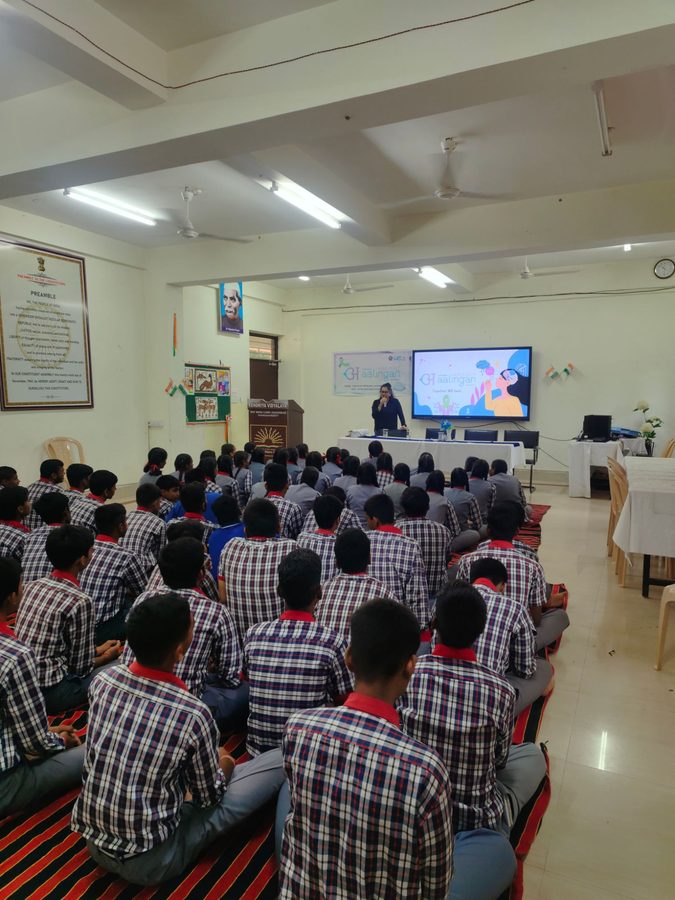 Students seated in uniform rows facing the speaker